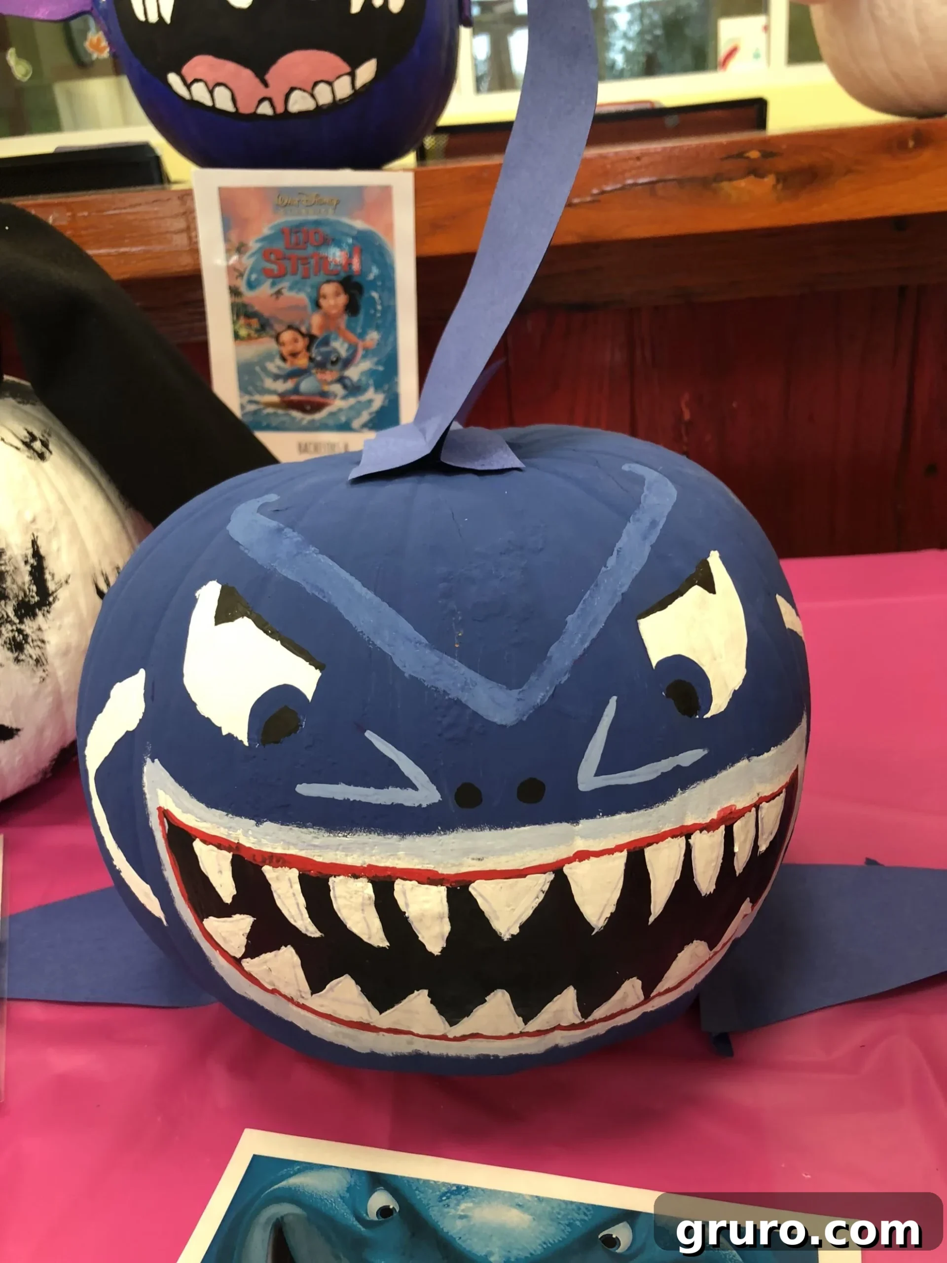 15 Creative No-Carve Pumpkin Decorations 9 Bruce the Shark from Finding Nemo depicted as a No-Carve Pumpkin, displayed on a pink table.