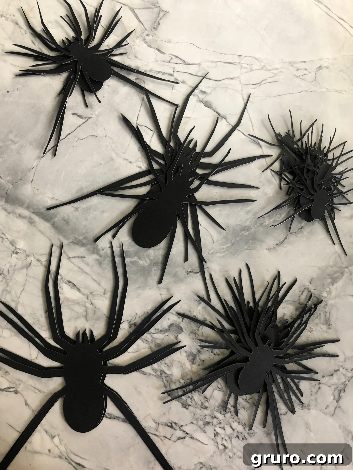 A stack of freshly cut paper spiders.