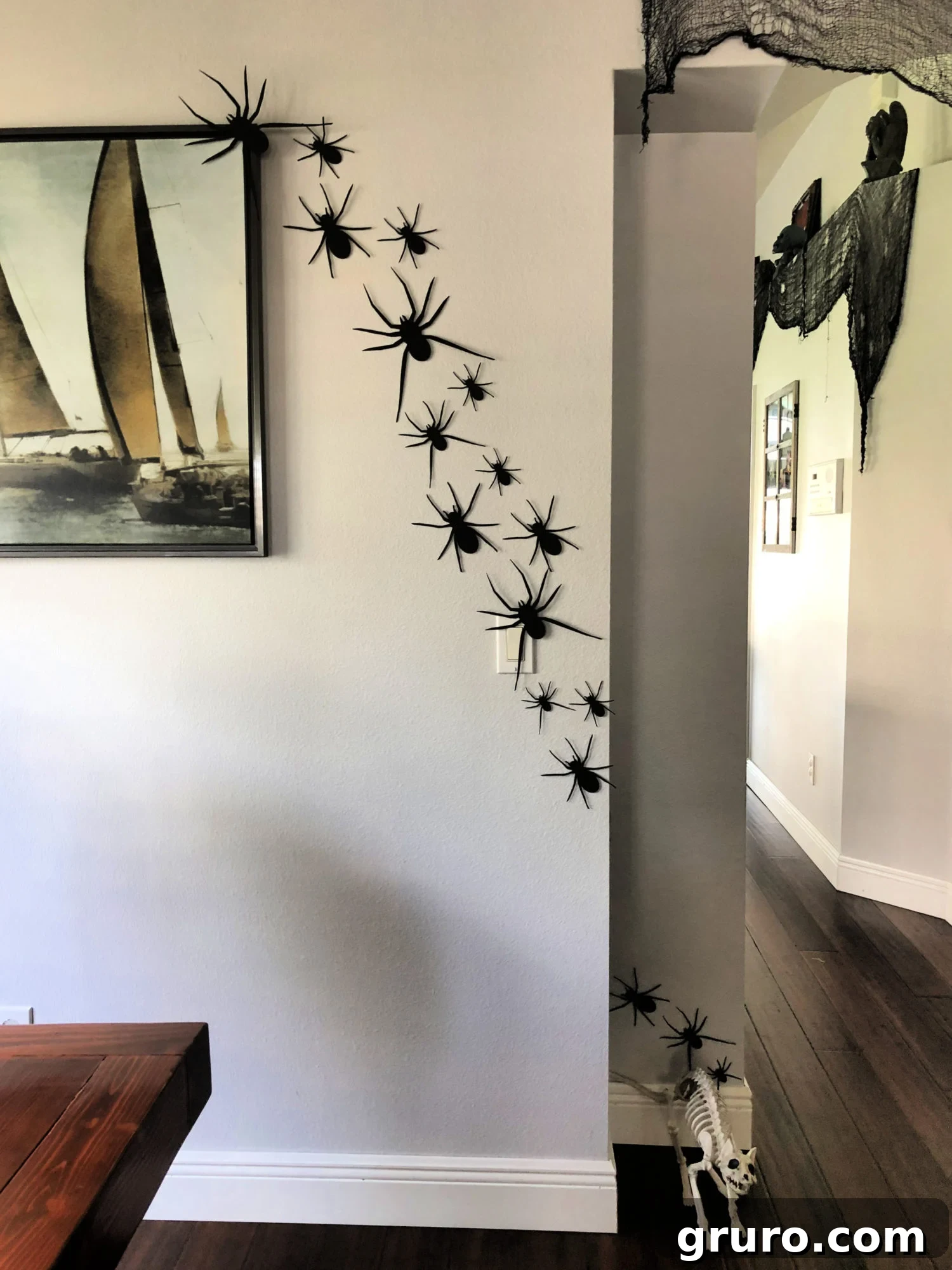 Halloween paper spider wall decor, with spiders wrapped around a corner.