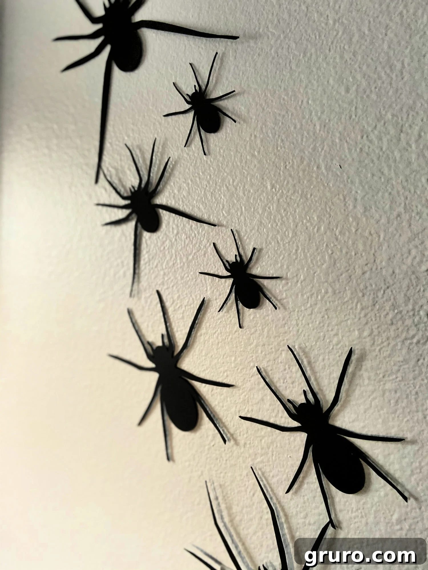 DIY Paper Spider Wall for Halloween Decor, showcasing the overall effect.