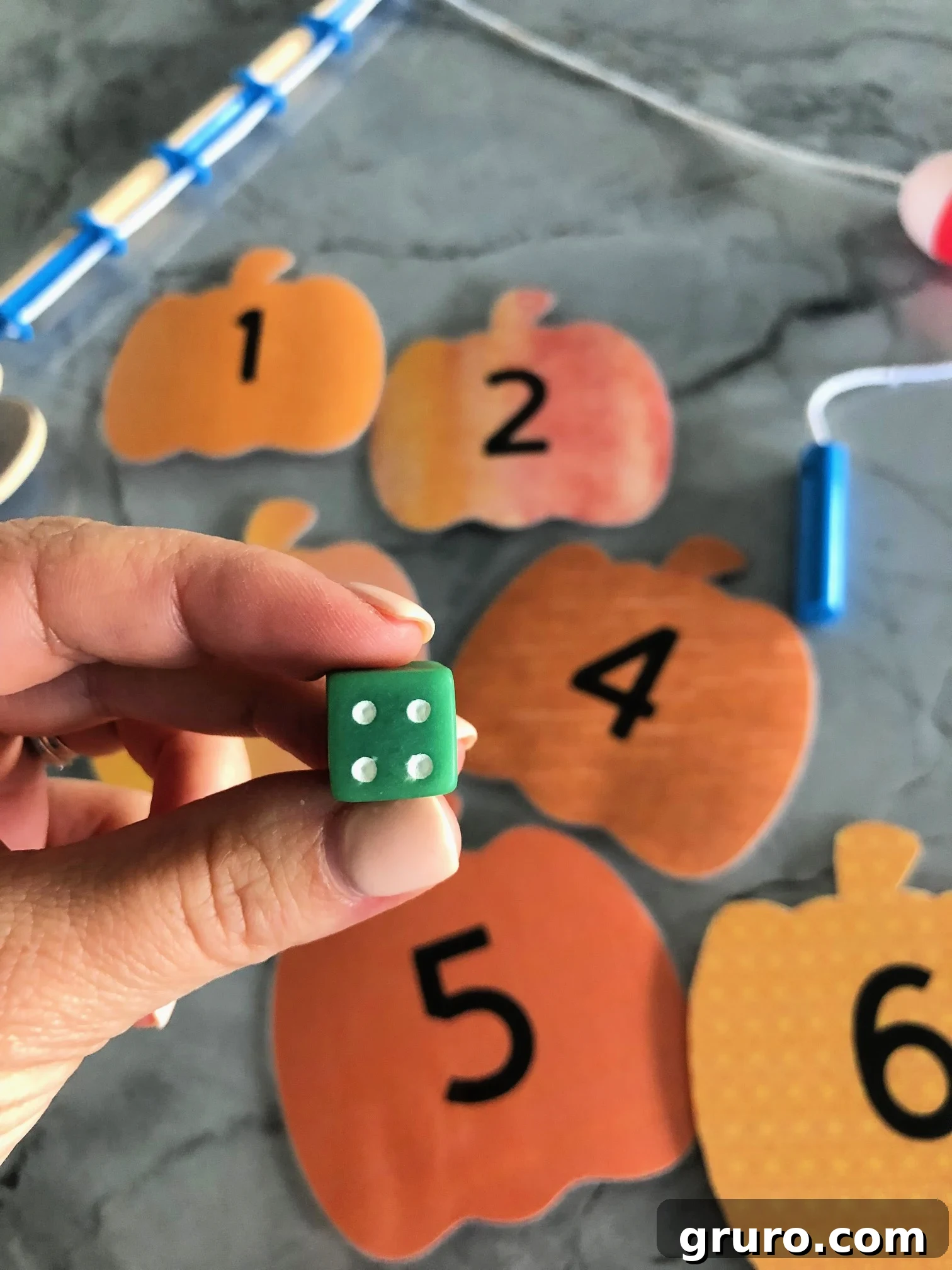 DIY Fishing for Numbered Pumpkins Game using a dice to determine which pumpkin to fish for!