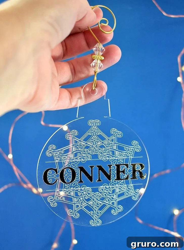 Beautifully engraved acrylic Christmas ornaments, featuring intricate snowflake designs made with a Cricut Maker.