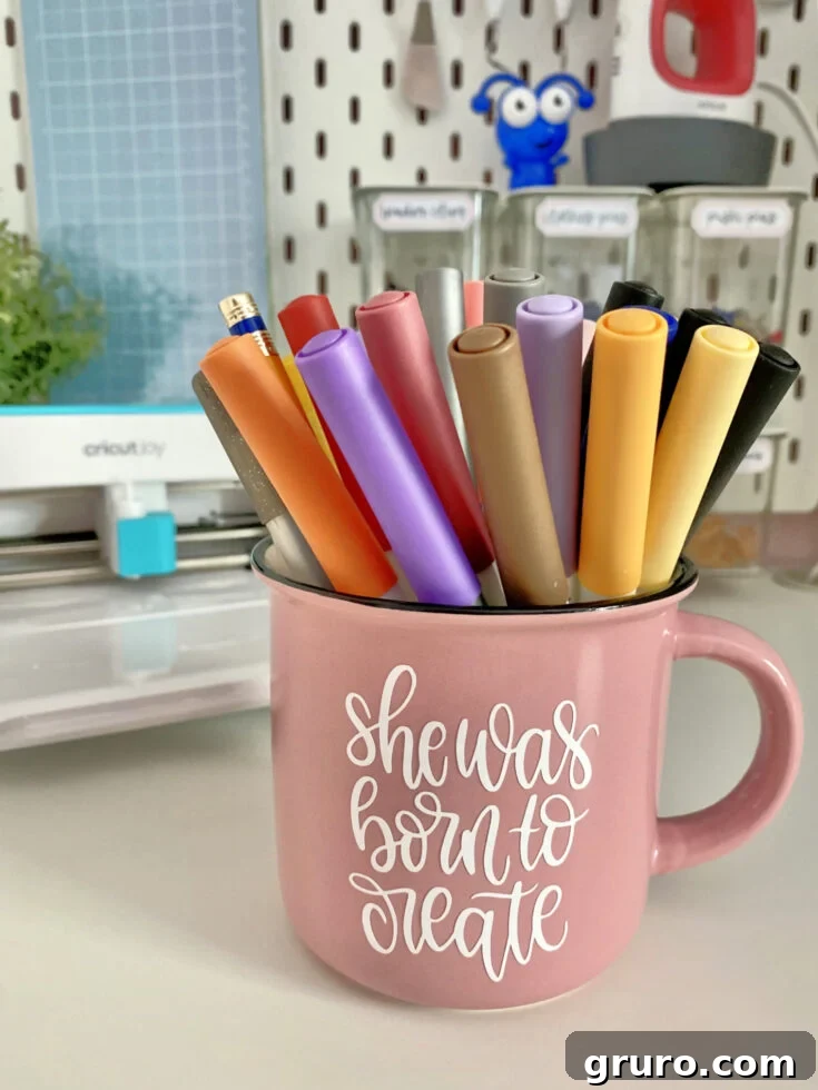 A personalized 'Born to Create' mug, made with vinyl and a Cricut Joy, symbolizing a passion for crafting.