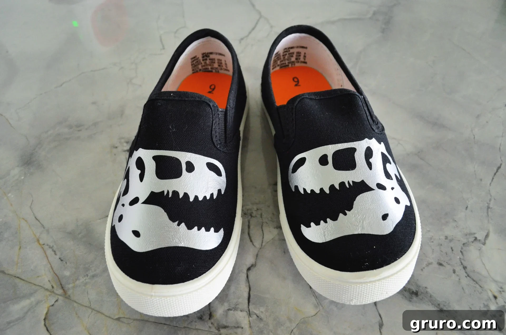Finished DIY Custom Shoes with the Cricut EasyPress Mini featuring dinosaur design