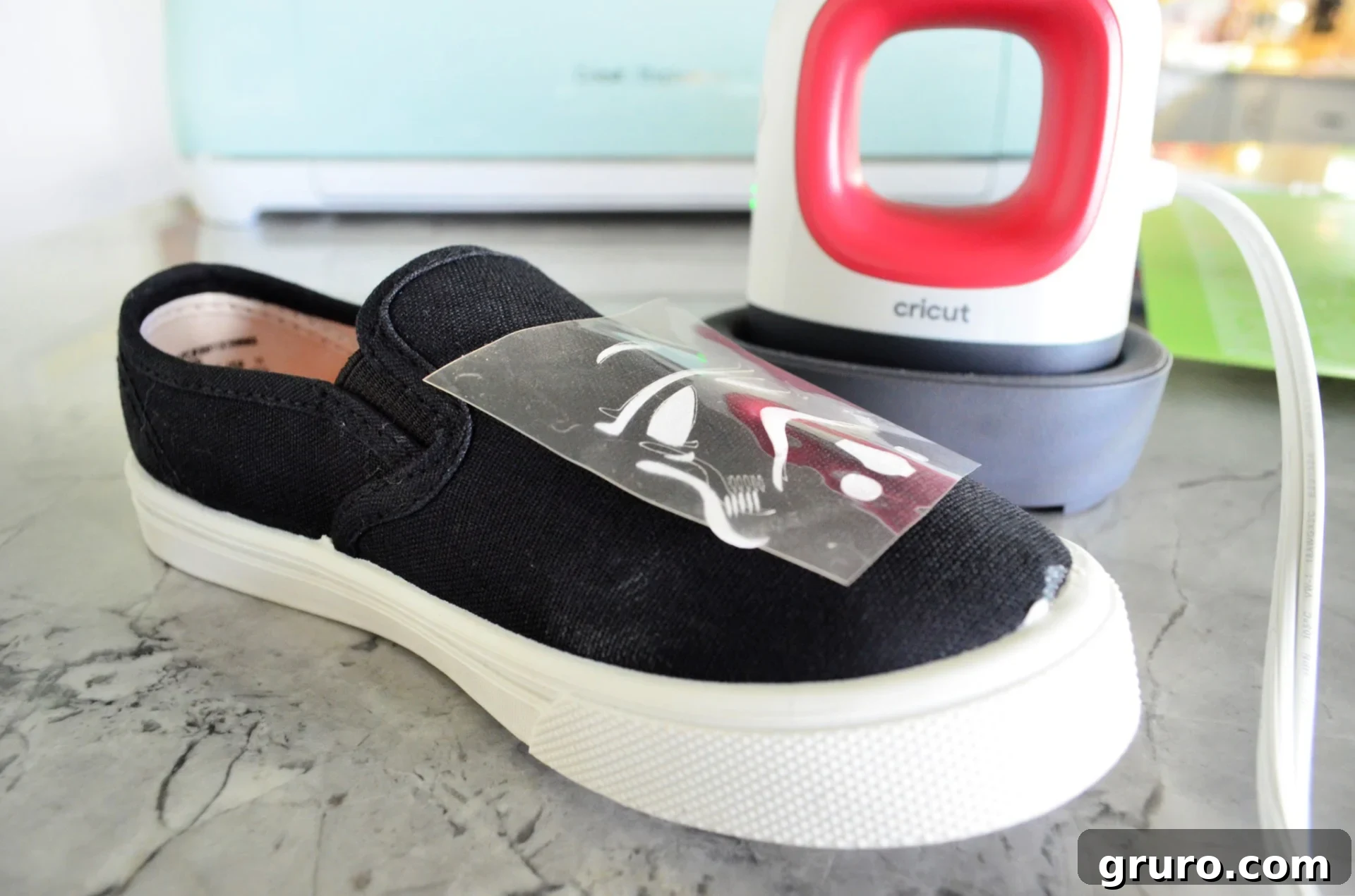 A close-up of a perfectly adhered Stormtrooper helmet iron-on vinyl design on a white canvas shoe, showcasing the seamless integration.