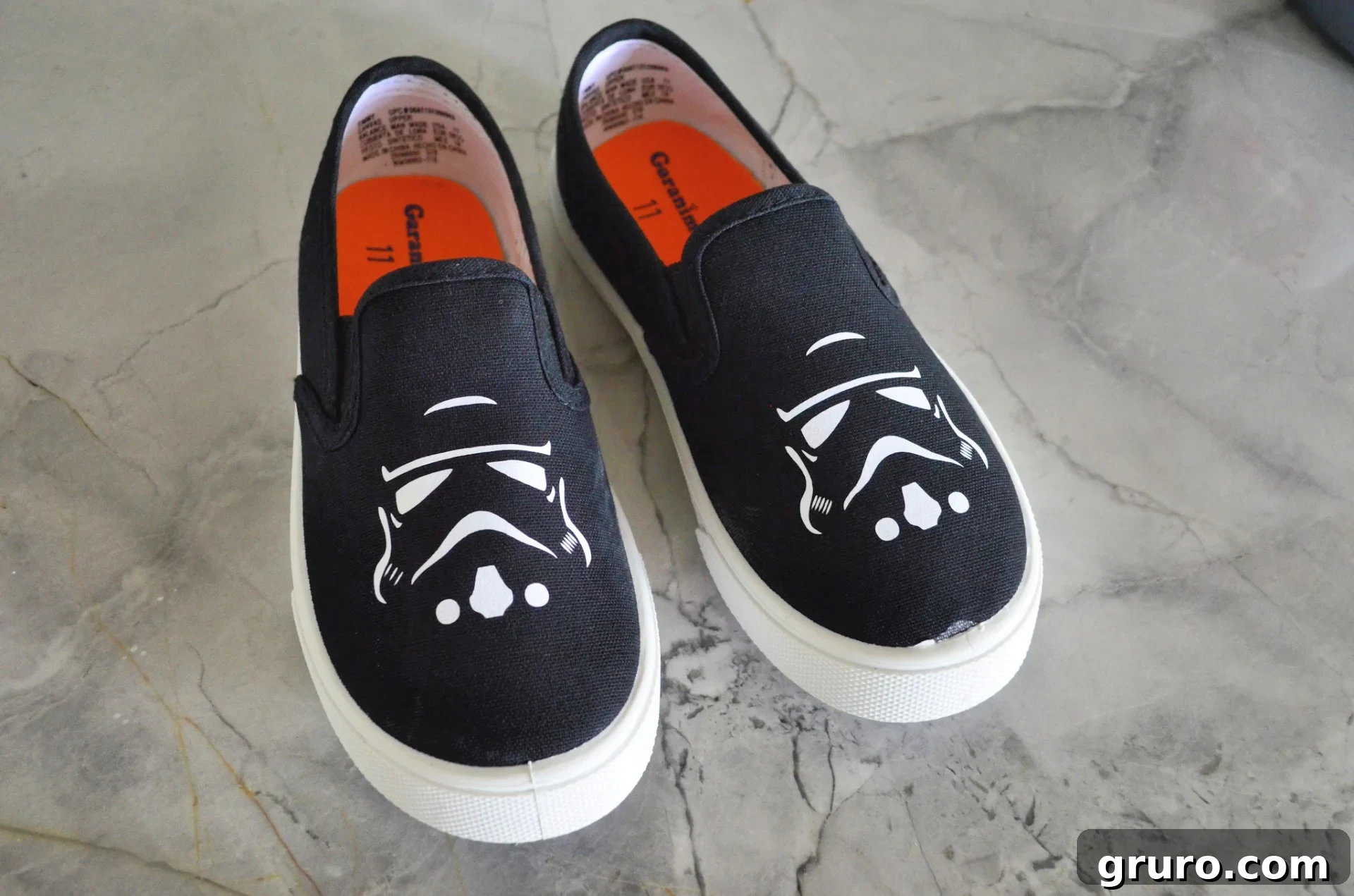 A young boy proudly wearing his new DIY Star Wars Stormtrooper Kids Shoes, showcasing the custom design on his white canvas sneakers.