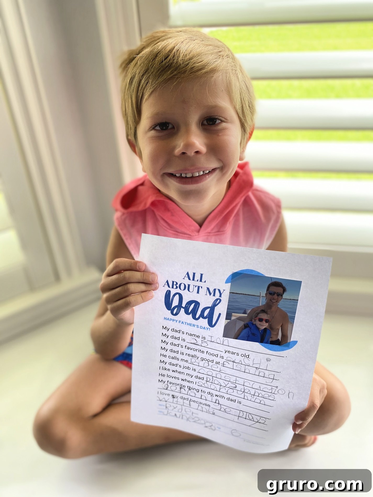 Happy child proudly holding up their finished Father's Day questionnaire.