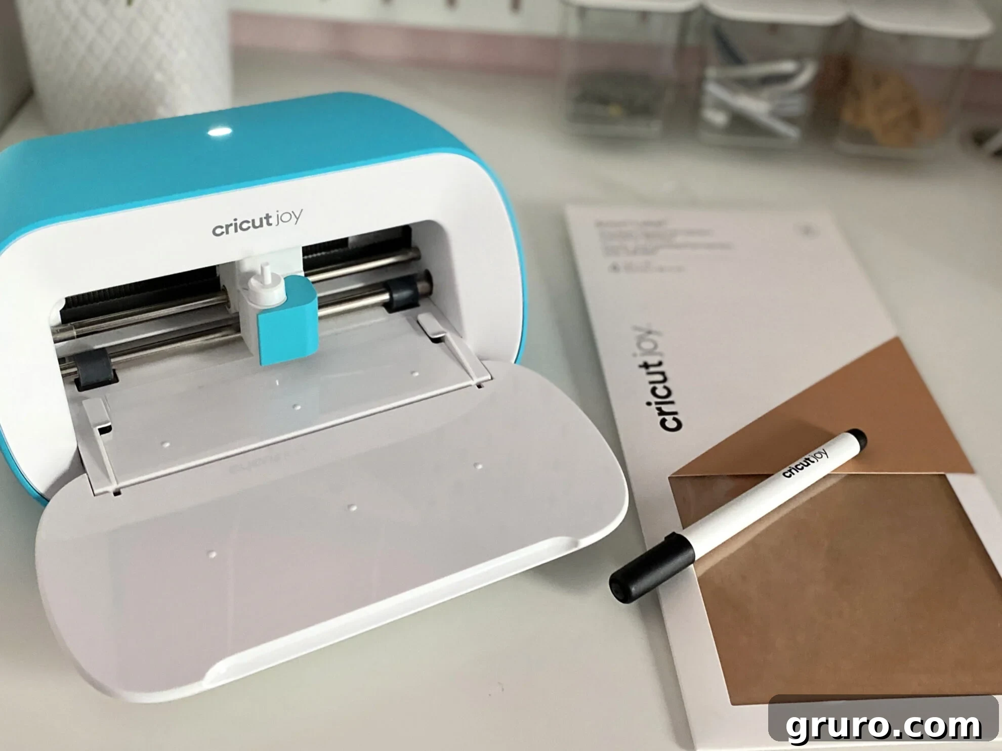 Essential supplies for creating custom file folder labels: Cricut Joy Smart Label Writable Paper, Cricut Joy Fine Point Pens, and a stack of file folders ready for organization.
