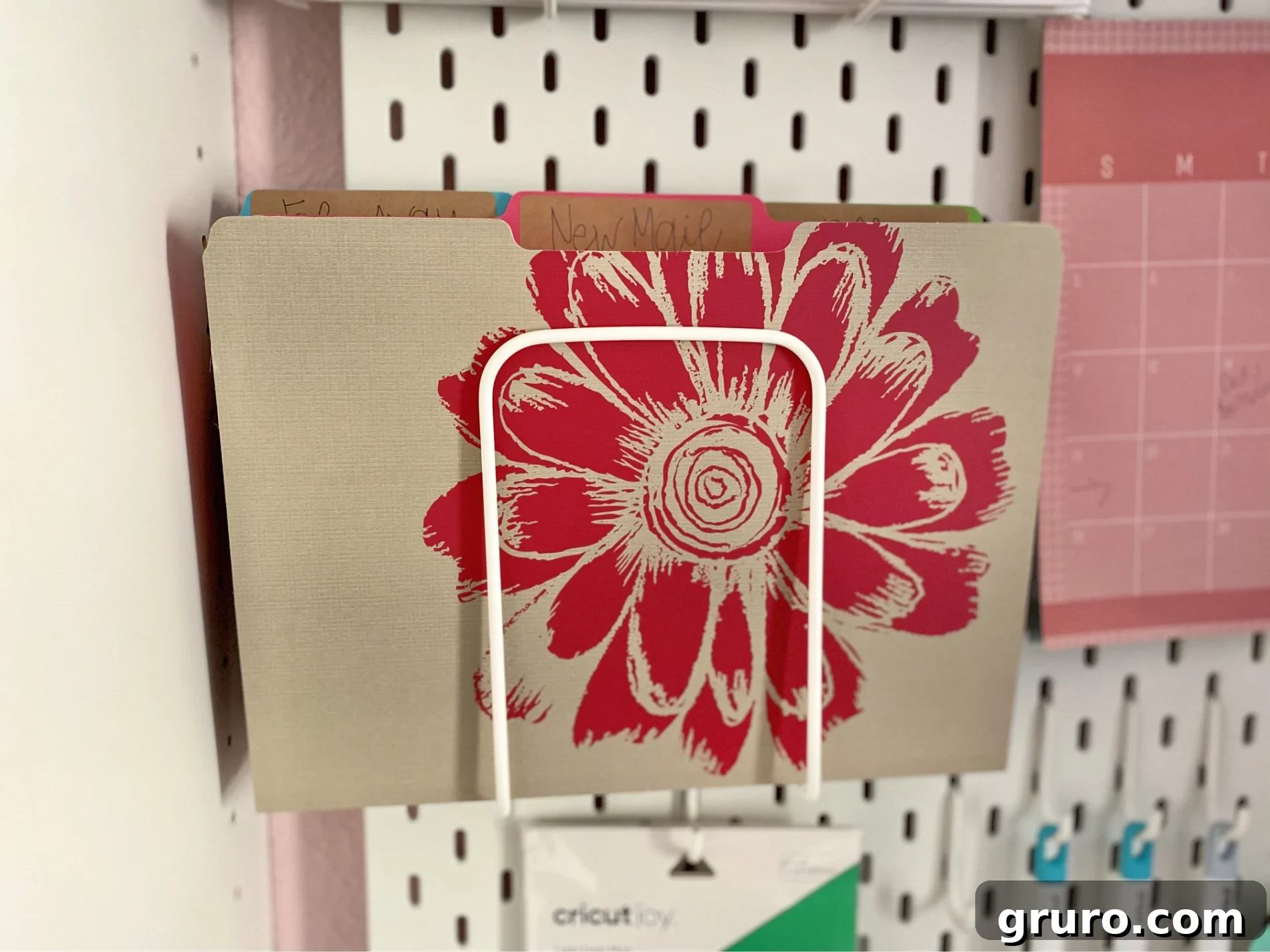A stack of file folders elegantly labeled with new, crisp labels created using the Cricut Joy, demonstrating a perfectly organized and refreshed office or craft system.