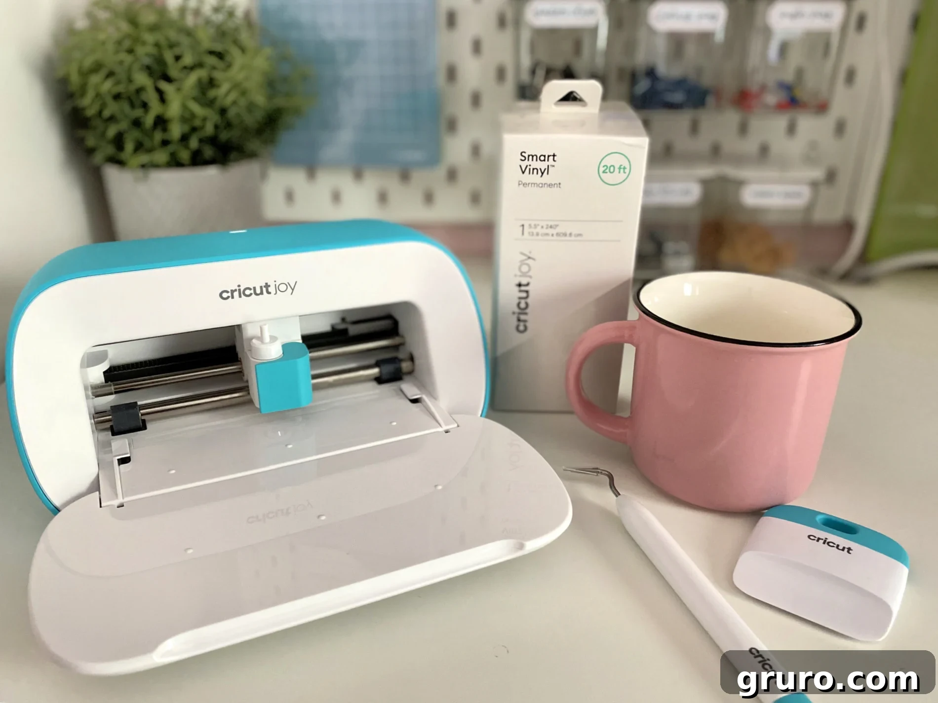 Cricut Joy machine alongside Cricut Joy™ Smart Vinyl™, Transfer Tape, and essential Cricut Joy Tools, neatly arranged on a crafting surface.