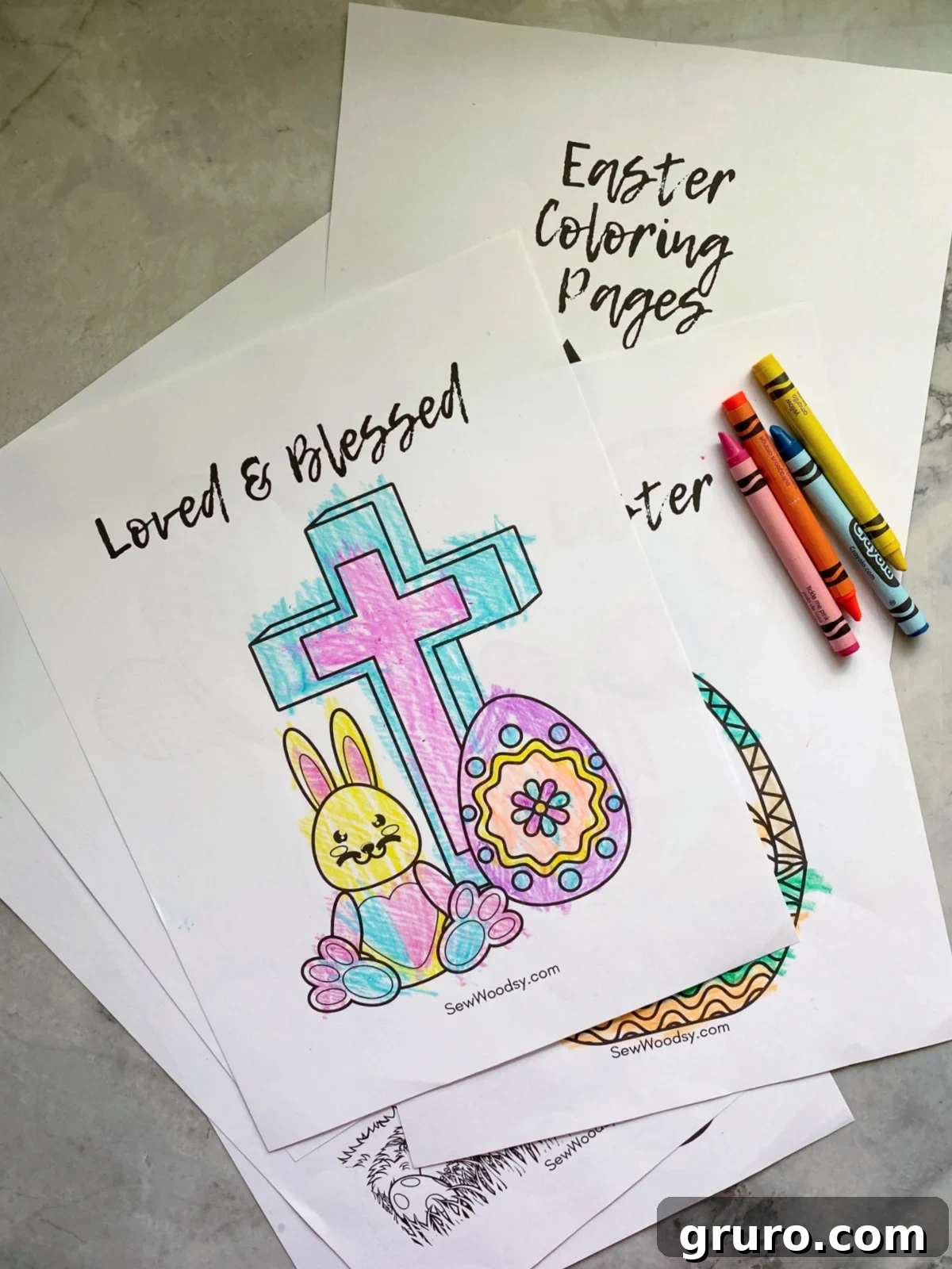 A vibrant selection of multiple Easter coloring pages featuring bunnies, eggs, and spring themes, laid out with four colorful crayons, inviting creative engagement.