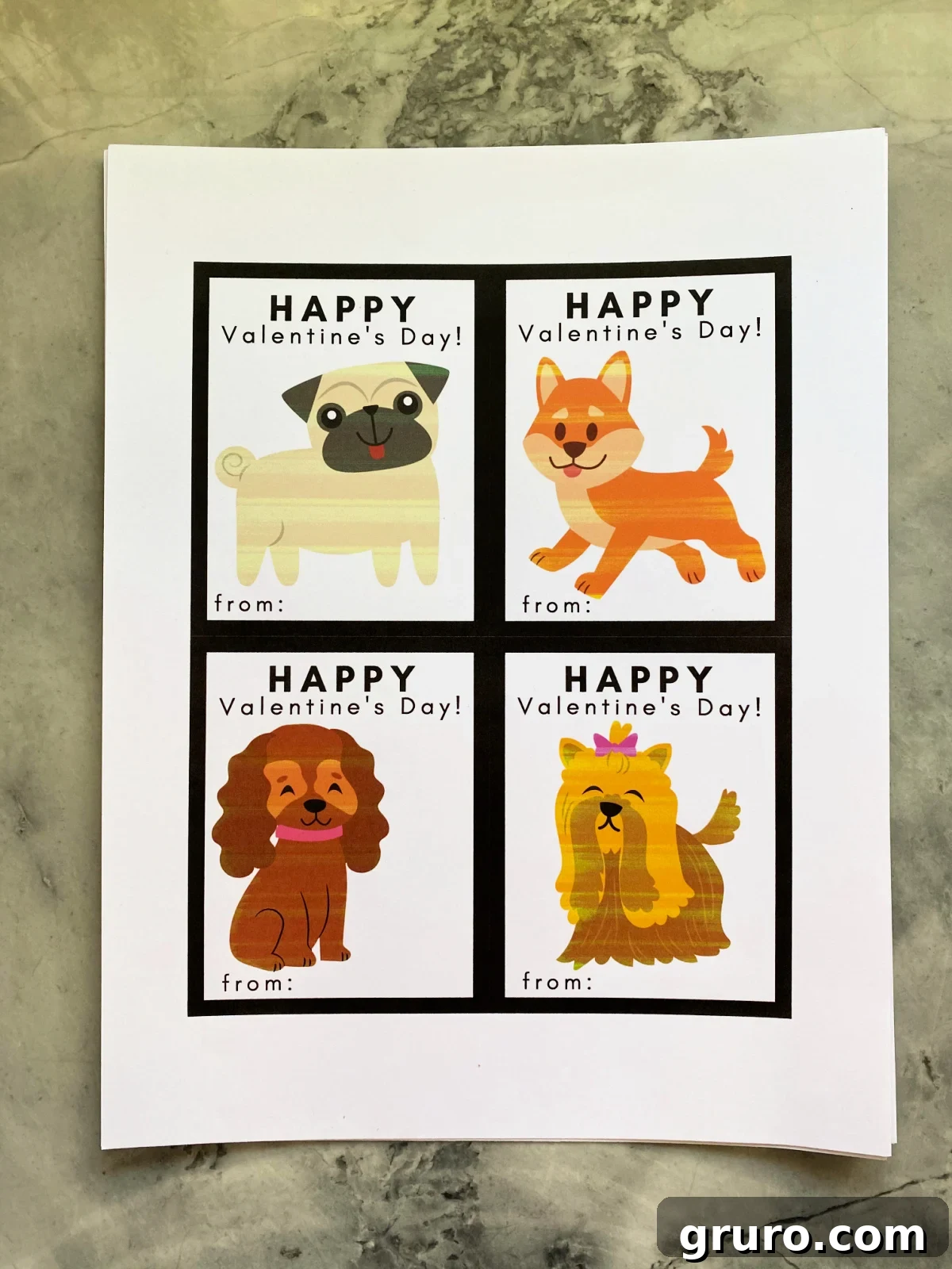 A pristine white sheet of paper showcasing four beautifully printed Doggie Valentine Cards, arranged perfectly and ready for the next step.