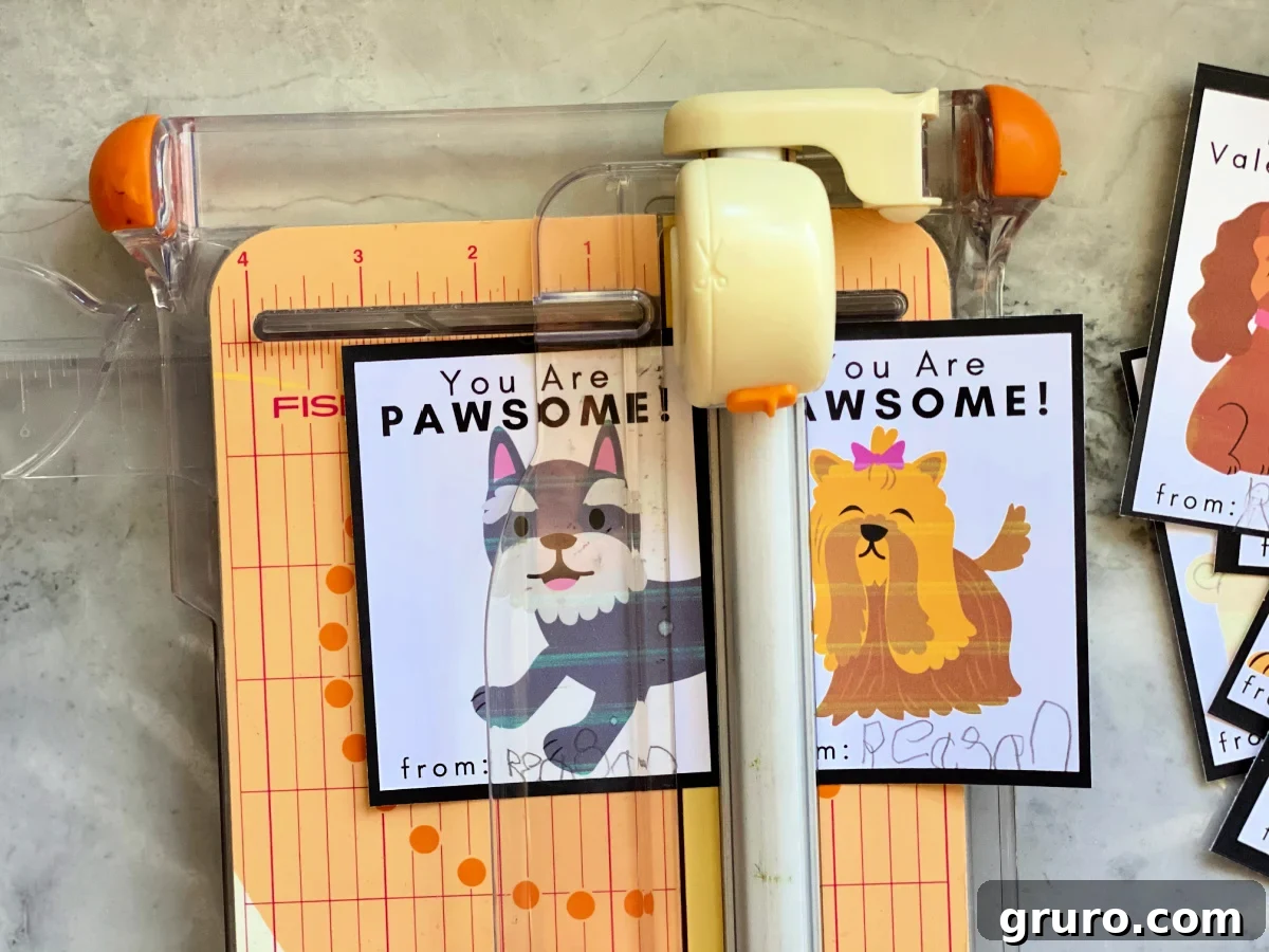 A pair of Doggie Valentine Cards being carefully cut on a paper cutter, ensuring straight and clean edges for a professional finish.