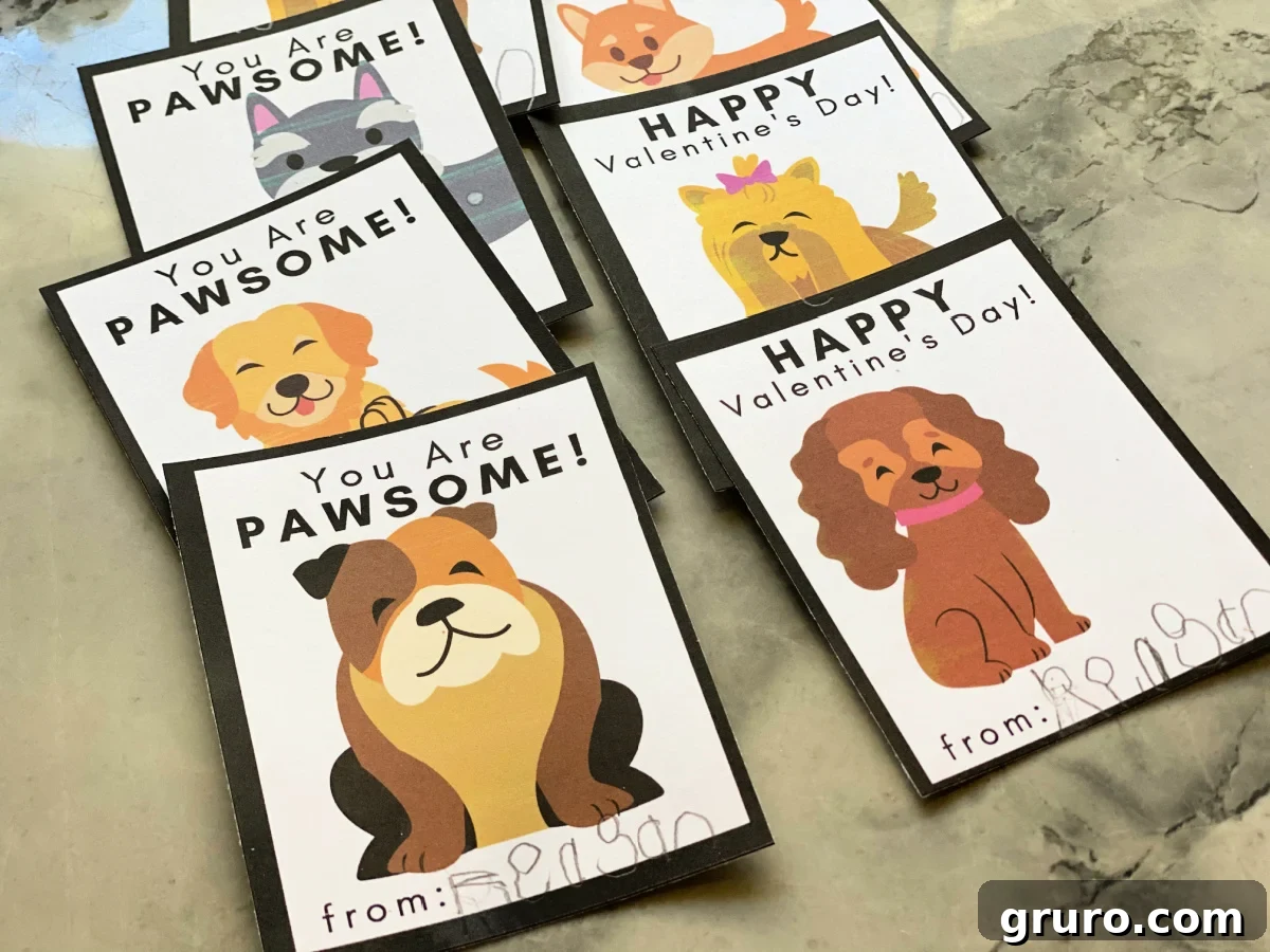 A neat stack of six completed Doggie Valentine Cards, showcasing the vibrant designs and ready for signing on a stylish marble countertop.