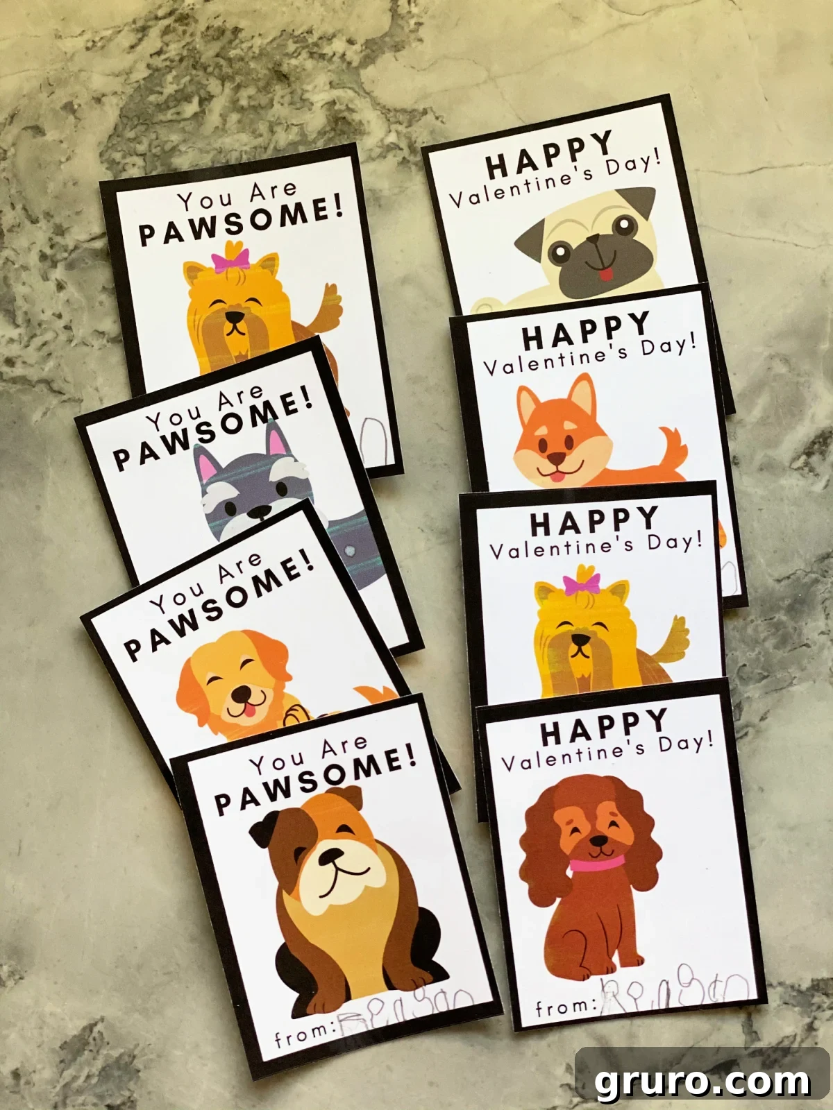 Eight charming Doggie Valentine Cards neatly arranged in two rows of four, set against a elegant marble backdrop, showcasing their variety and appeal.