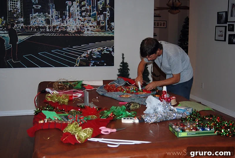 Close-up of various crafting supplies for tacky sweaters, including glitter and ornaments.