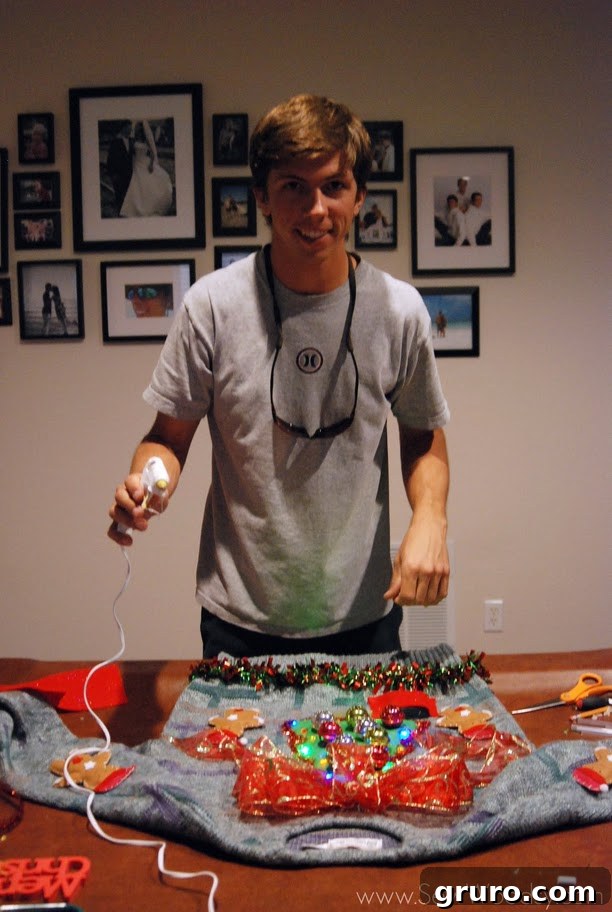 Close-up of crafting supplies, including a hot glue gun, on a pool table.