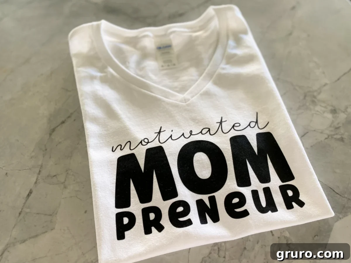 White folded shirt that saays motivated mompreuner.