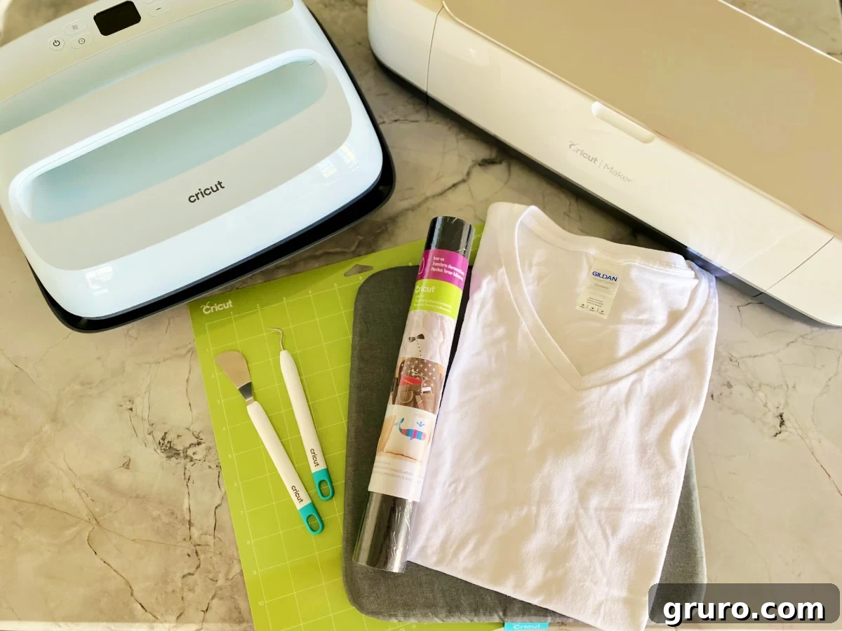 Supplies on counter; Cricut EasyPress, Cricut Maker, green mat, spatula, weeding tool, tshirt, and iron on vinyl.