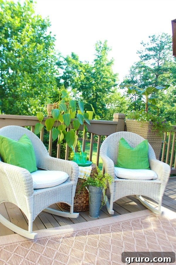 Green and refreshed deck with spray painted wicker chairs, showcasing an inviting outdoor space for relaxation and entertaining.