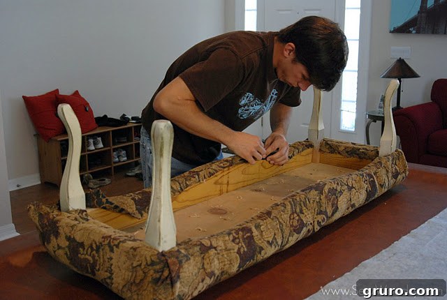 Underside of the bench with bottom liner removed, revealing old tufting marks.