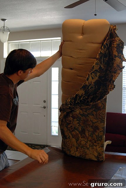 Close-up of fabric being removed from the bench, revealing inner layers.