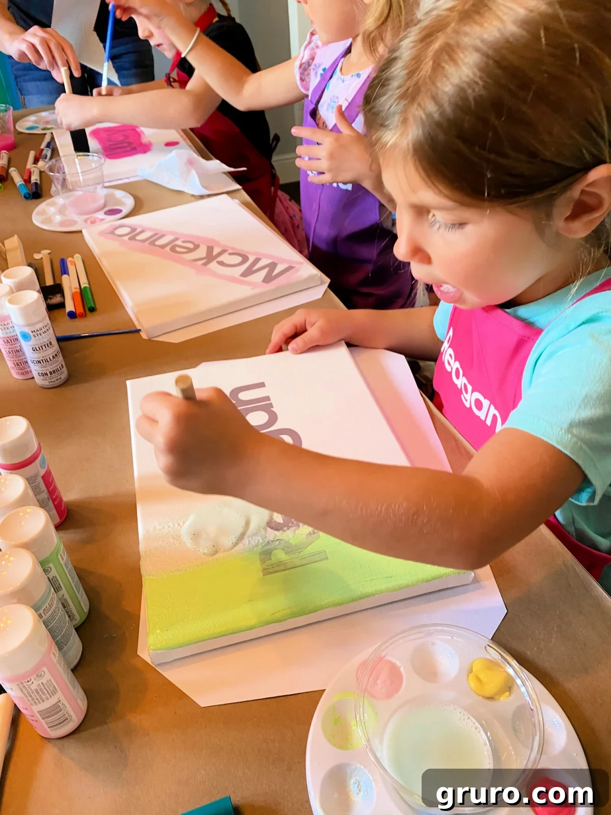 Little girl painting on a canvas.