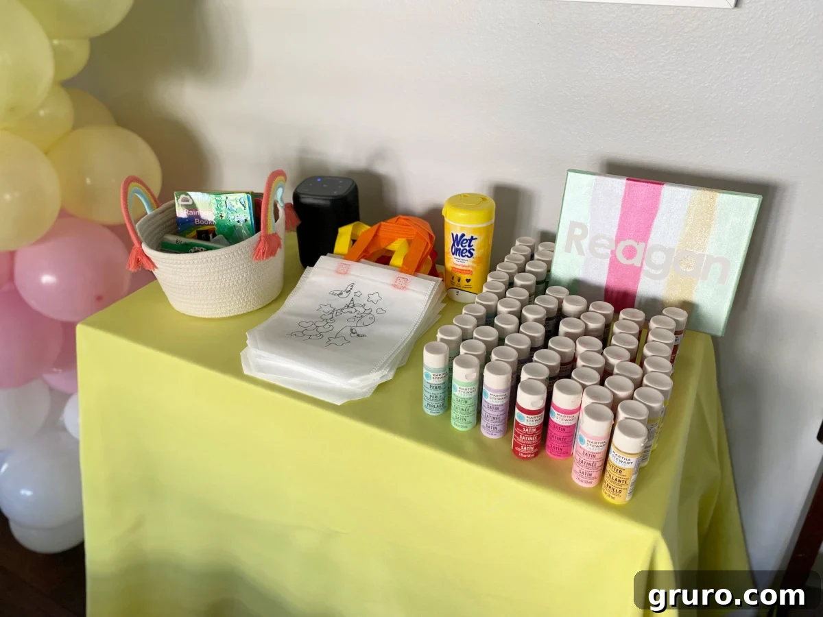 Yellow table cloth with paints, canvas, and coloring bags.