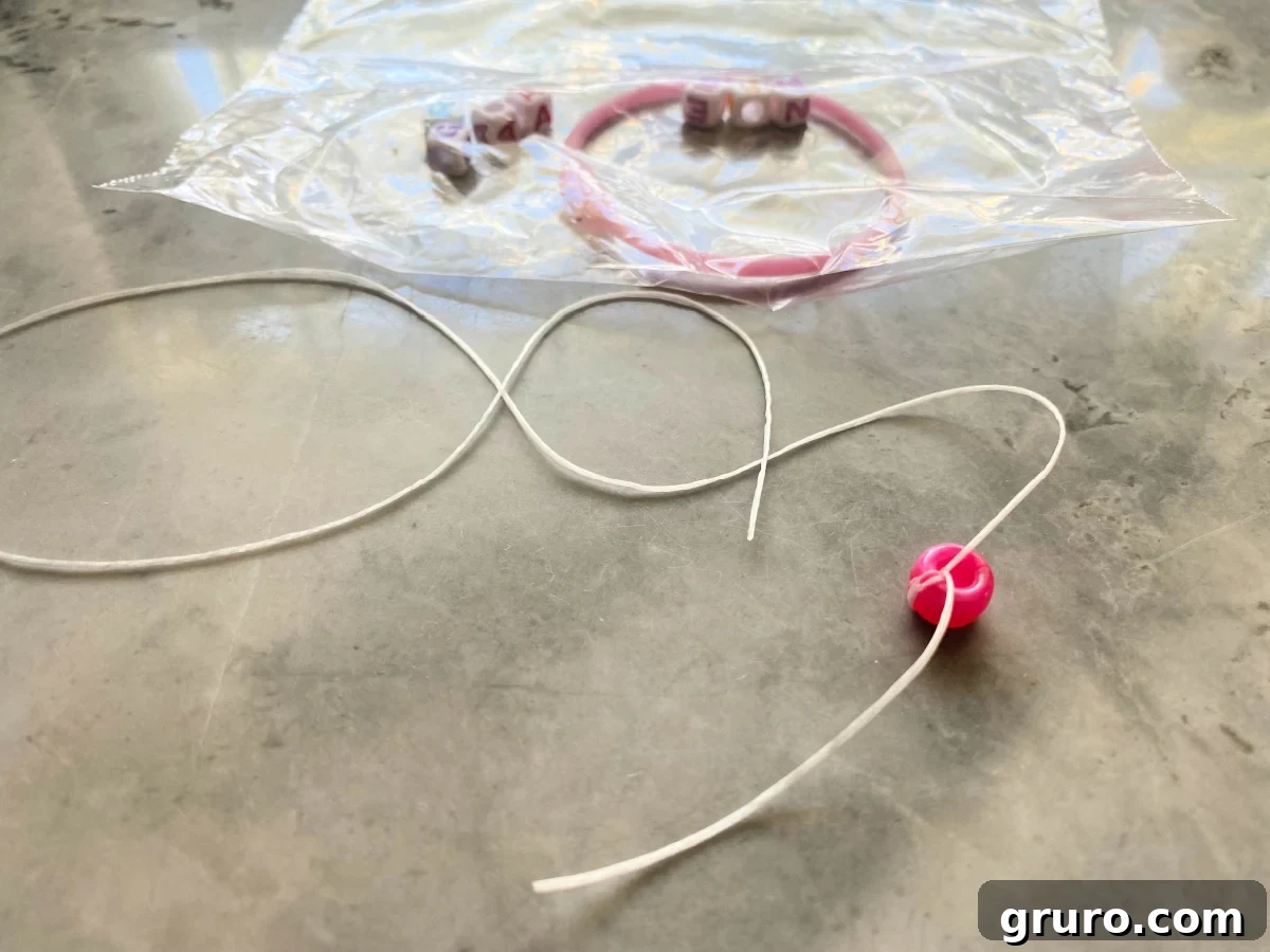 Bead tied on elastic necklace on a countertop.