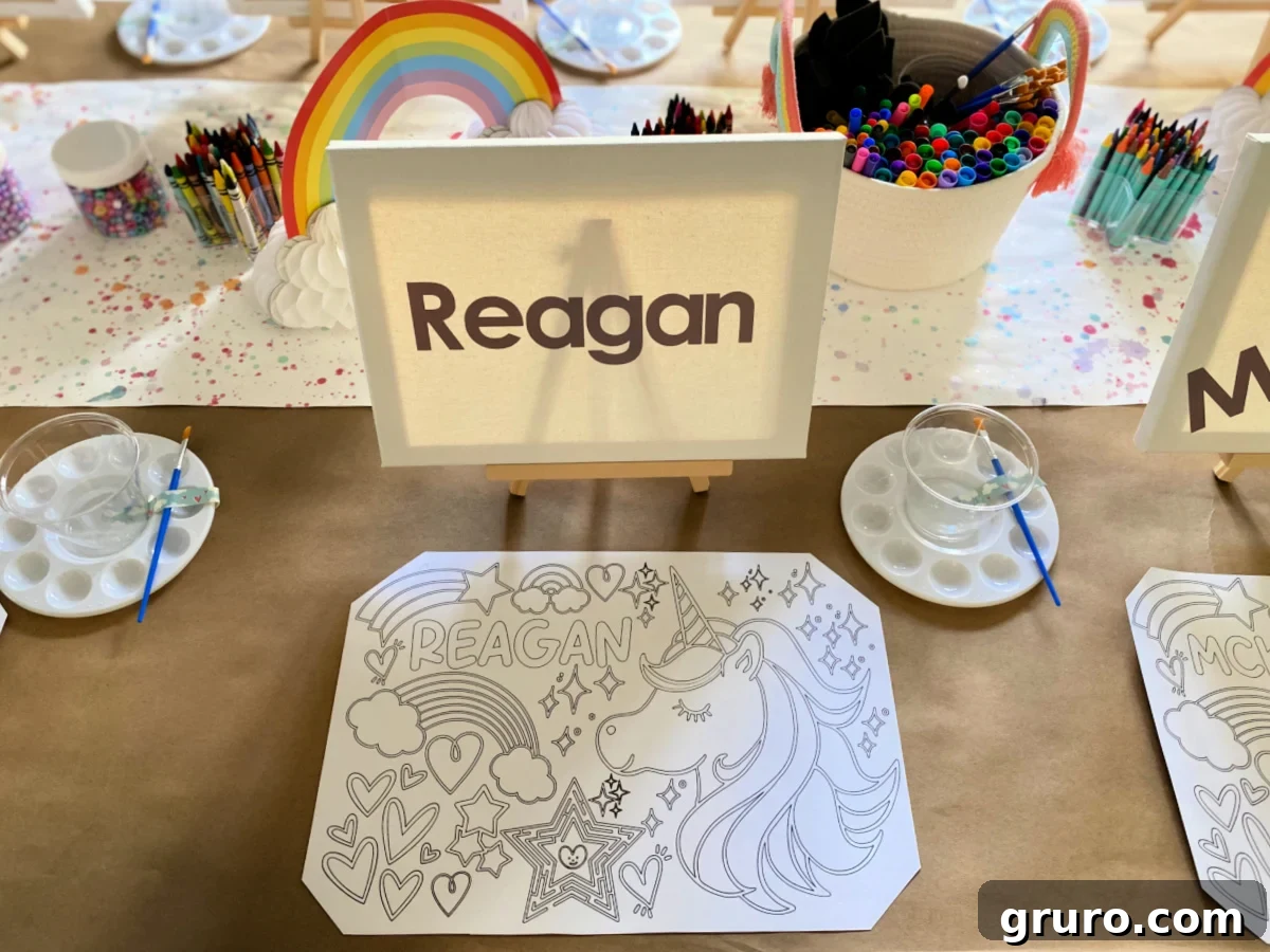 Unicorn coloring mat with easels and canvas on top with paint pallette, brush, and cup next to it.