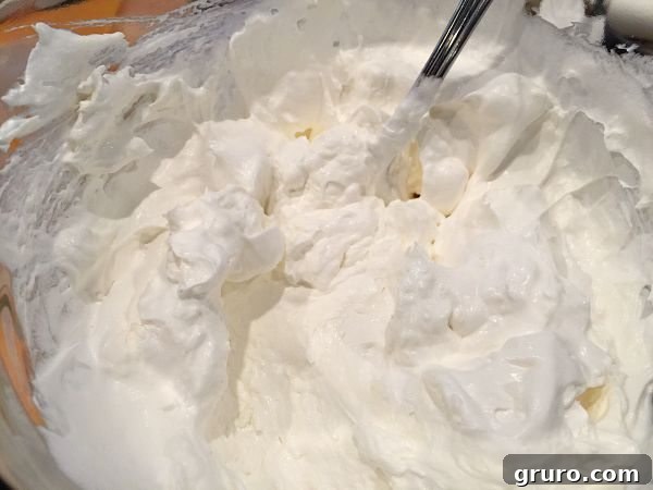 Blending cream cheese and Cool Whip for Butterfinger Pie