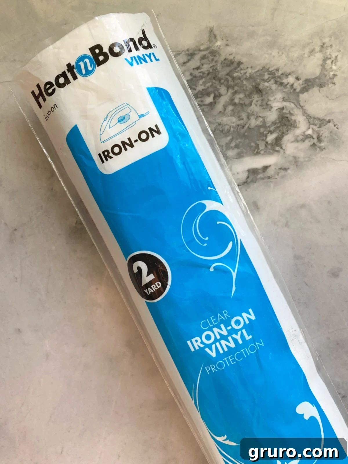Heat n bond vinyl tube in packaging on a marble countertop.