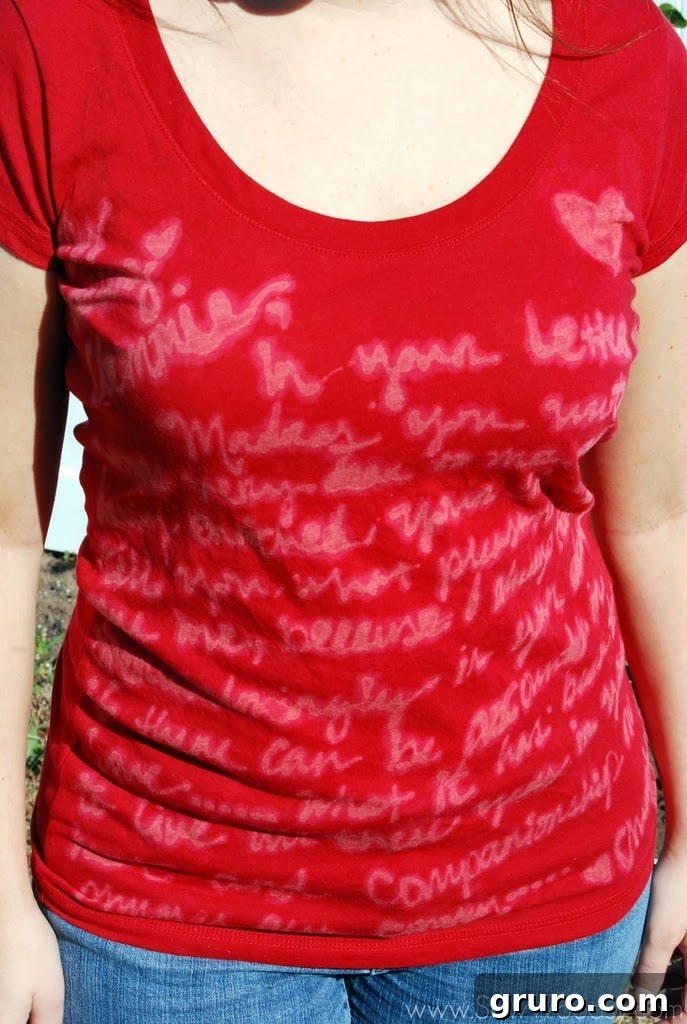 A personalized dark t-shirt featuring a custom love letter design, beautifully created with a bleach pen, elegantly displayed to showcase the finished DIY apparel.