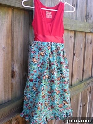 A vibrant paisley fabric and an old tank top, ready for an upcycling project, laid out on a surface.