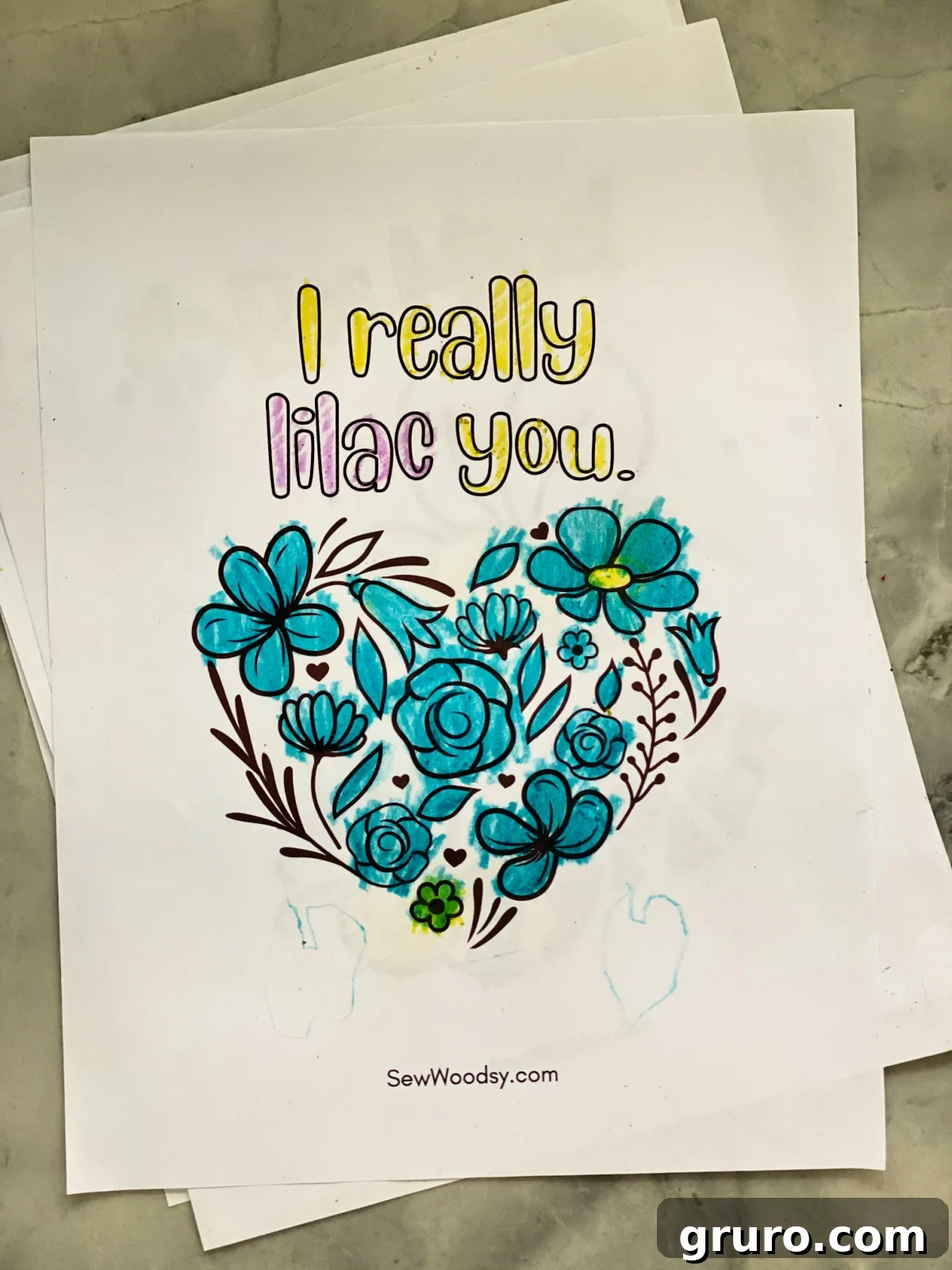 Sweetheart Valentine's Coloring Fun 4 A beautiful heart shaped by intricate flowers on a white paper, accompanied by the playful words "I really lilac you."