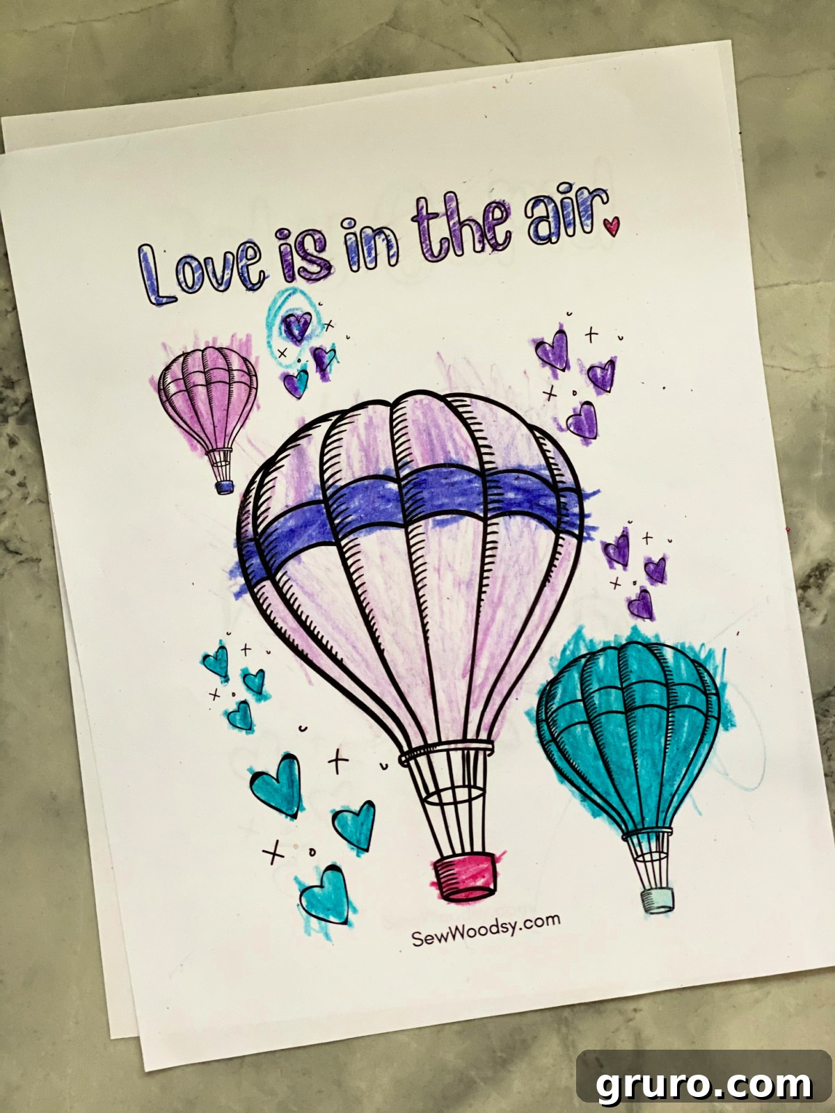 Sweetheart Valentine's Coloring Fun 5 Three whimsical hot air balloons floating across a white page, featuring the romantic message "Love is in the Air."