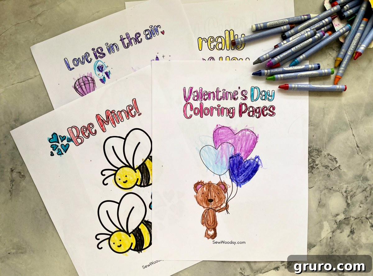 Sweetheart Valentine's Coloring Fun 6 Top view of four vibrant Valentine's Day coloring pages for kids, with an assortment of colorful crayons scattered on the surface.