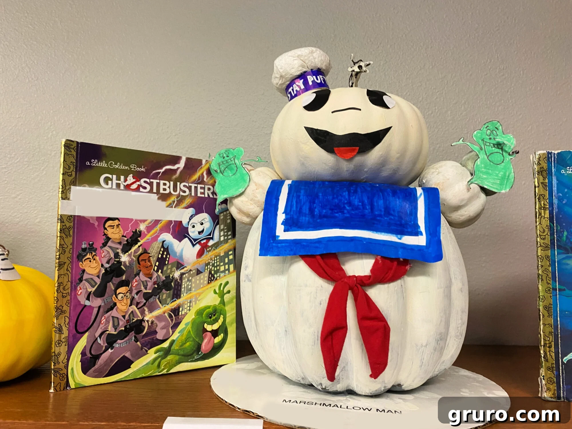 White marshmallow pumpkin next to a Ghostbusters book.