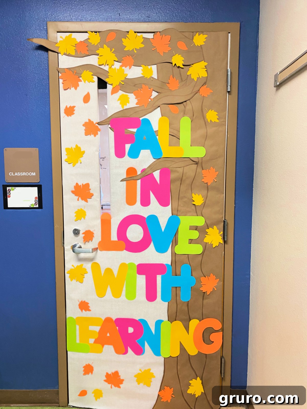 Large tree with fall leaves and the words "fall in love with learning"