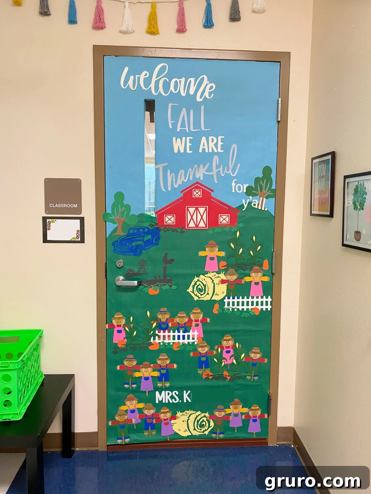 Farm inspired classroom door with scarecrows scattered around the door.
