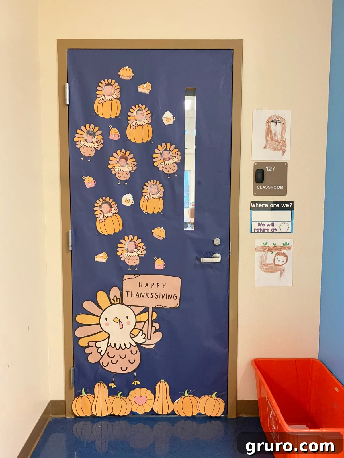 Blue classroom door decorated with a large turkey and small turkeys with kids faces on it.
