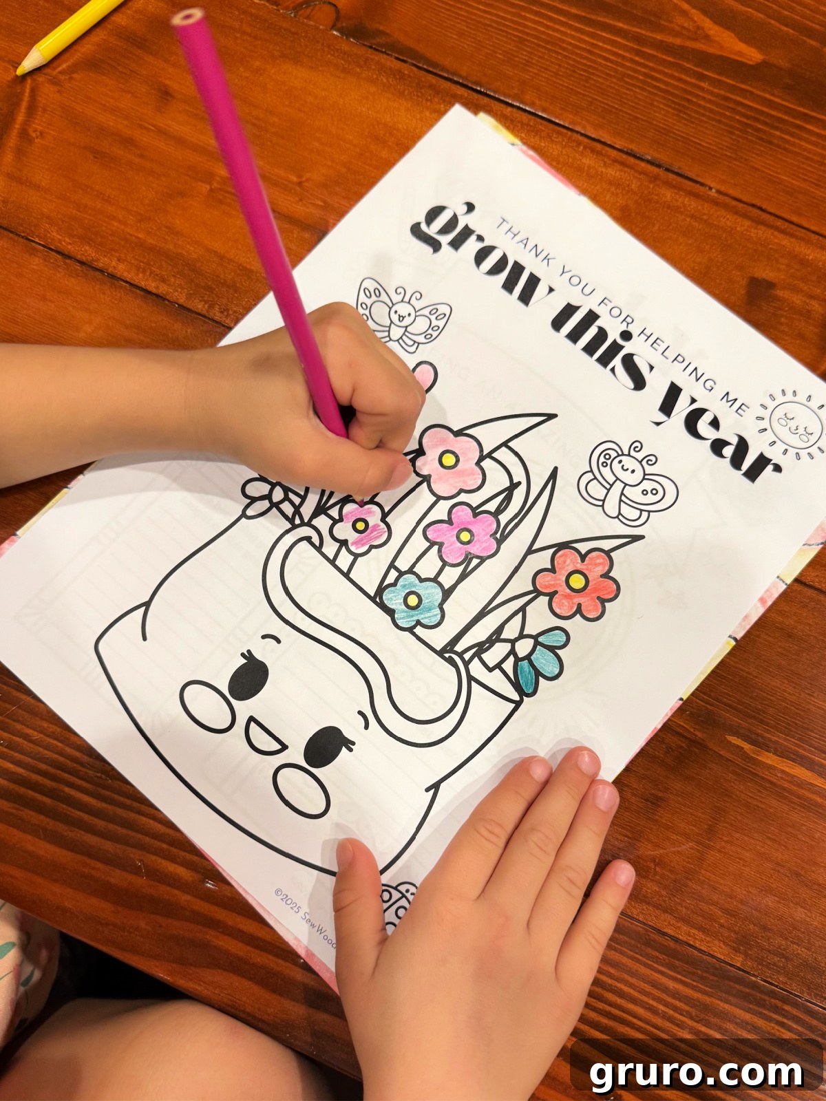 Printable Teacher Gratitude Gifts 4 Little girl coloring a plant-themed coloring page on a wood table, a message of 'Thank you for helping me grow this year'.