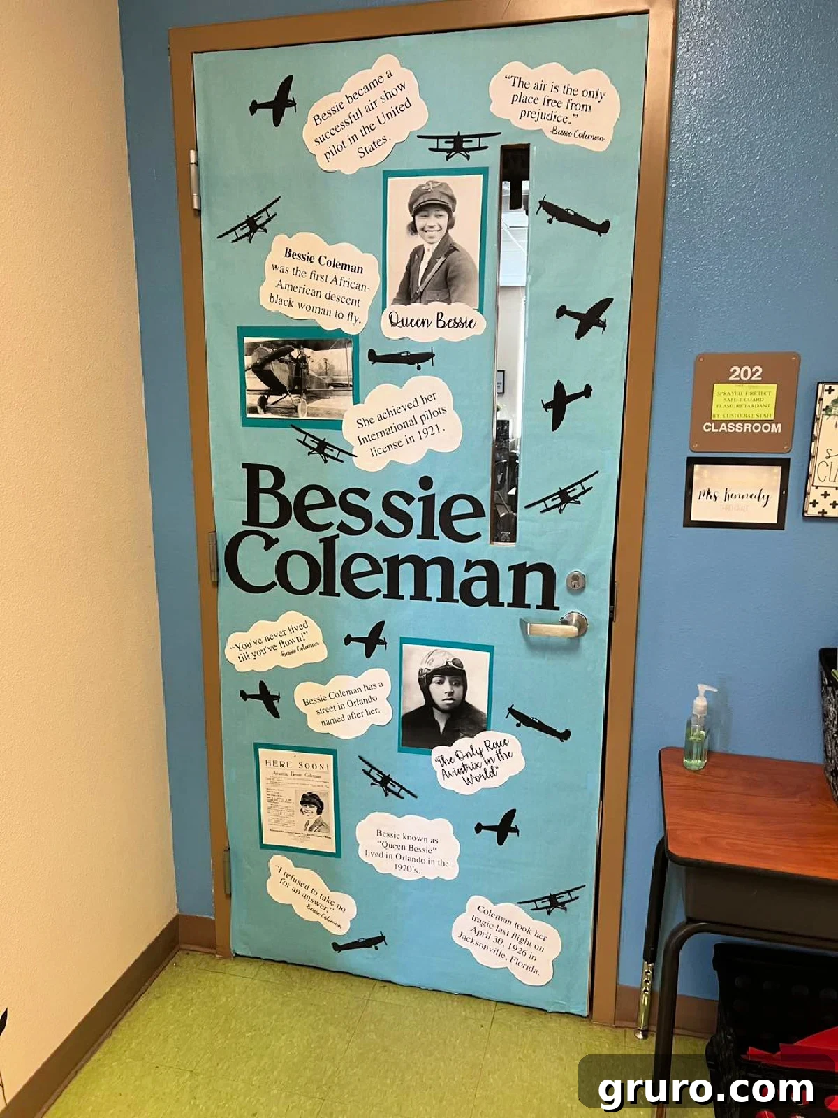 Blue door with airplanes and the name "Bessie Coleman" and clouds with quotes and facts about her.