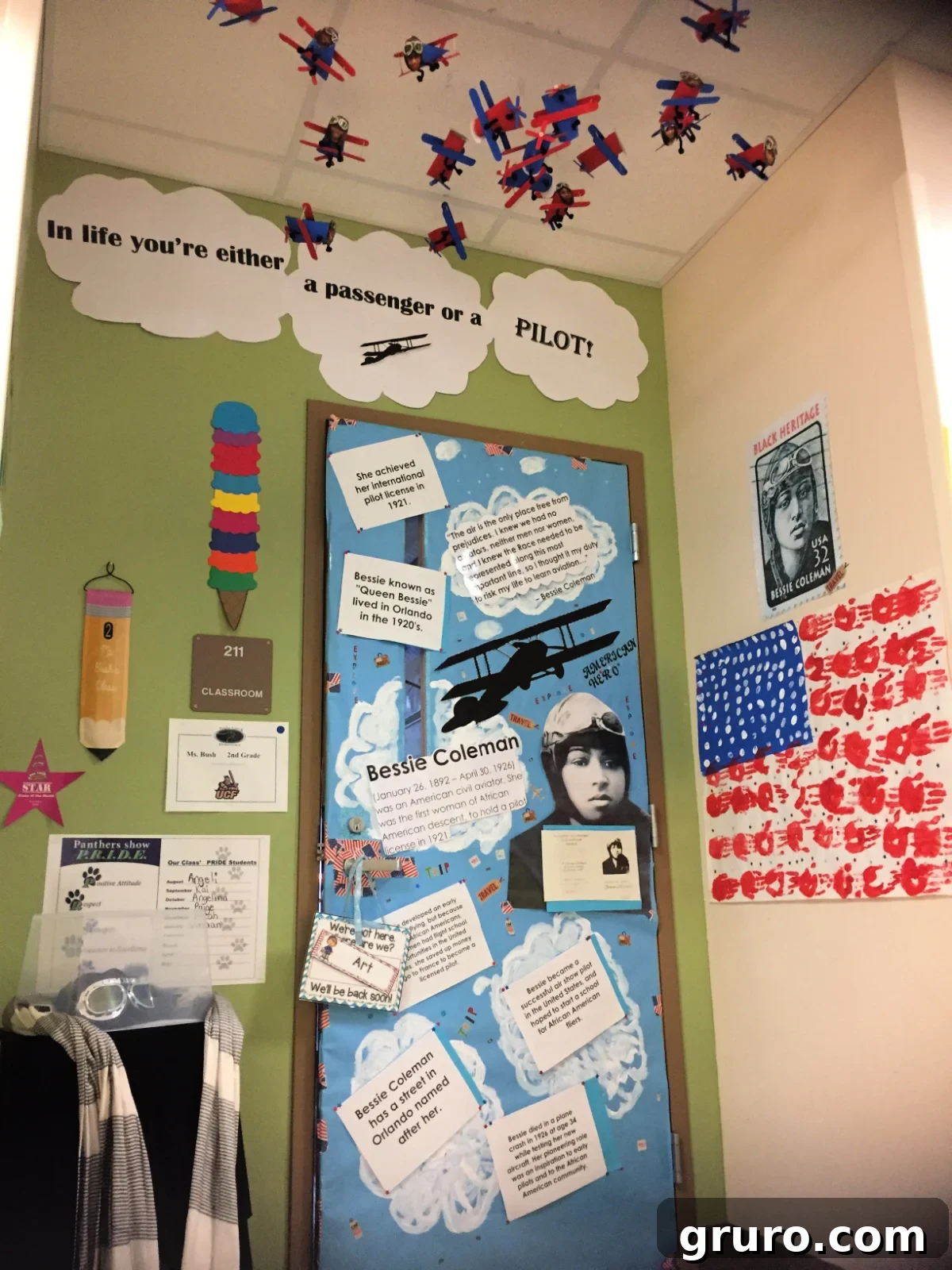 Bessie Coleman on the door with blue paper and clouds.