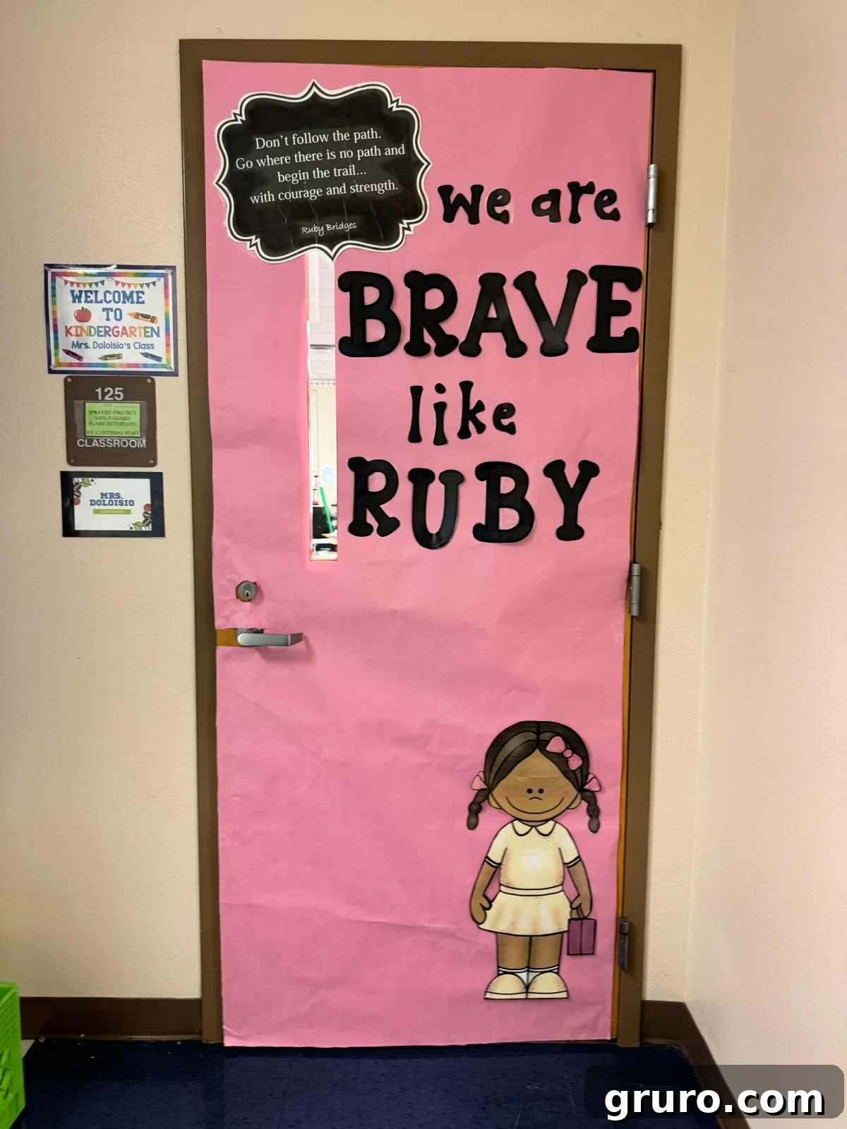 Pink door with "we are brave like Ruby" and a little black girl on door.