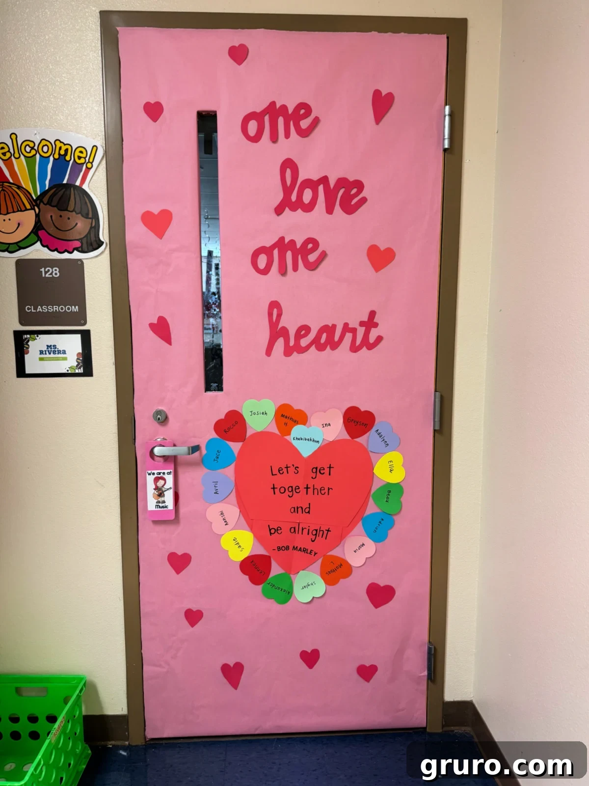 Pink door with "one love one heart" and hearts with kids names on it.