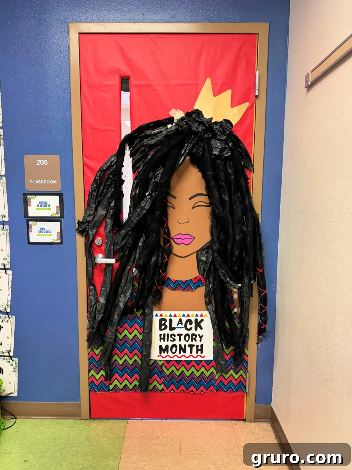 Red door with african american woman with dreadlocks and a sign that reads Black History Month.