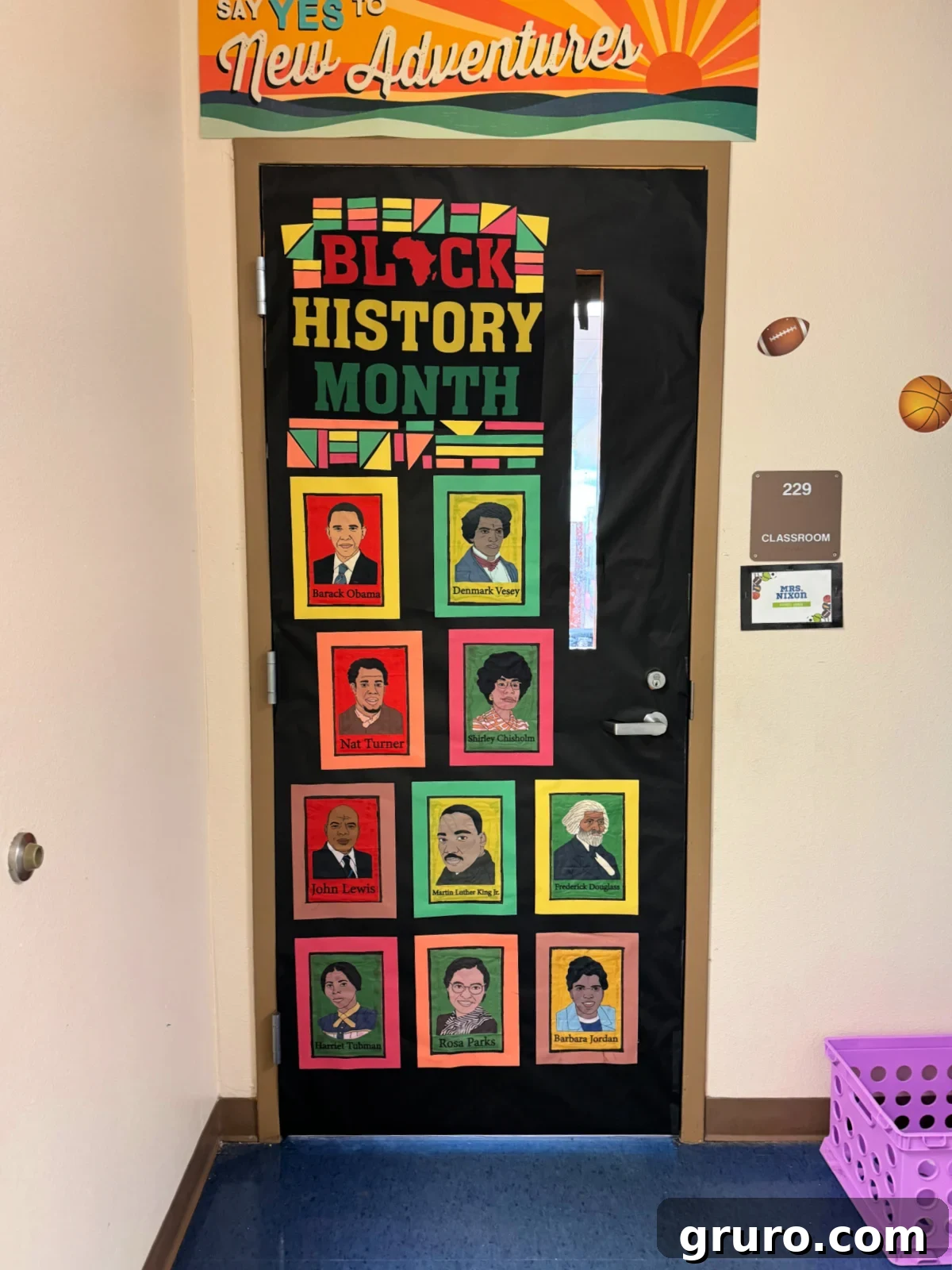 Black door with "black history month" and photos of influential Black historians.