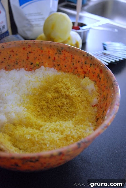 Close-up of several green tea bags being opened and their contents added to the scrub mixture.