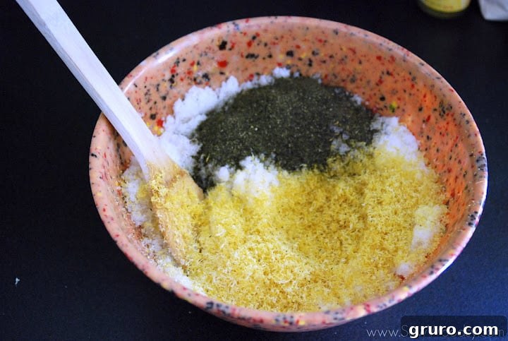 The sugar scrub mixture after green tea has been added, showing a greenish tint and speckled texture.